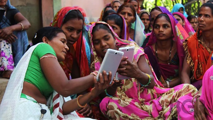 Women beneficiaries of ETASHA's adult literacy program practicing on their phone