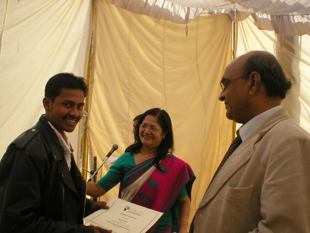 Dr. Meenakshi Nayar and the guest of honour awarding certificate of completion to one of the beneficiaries.